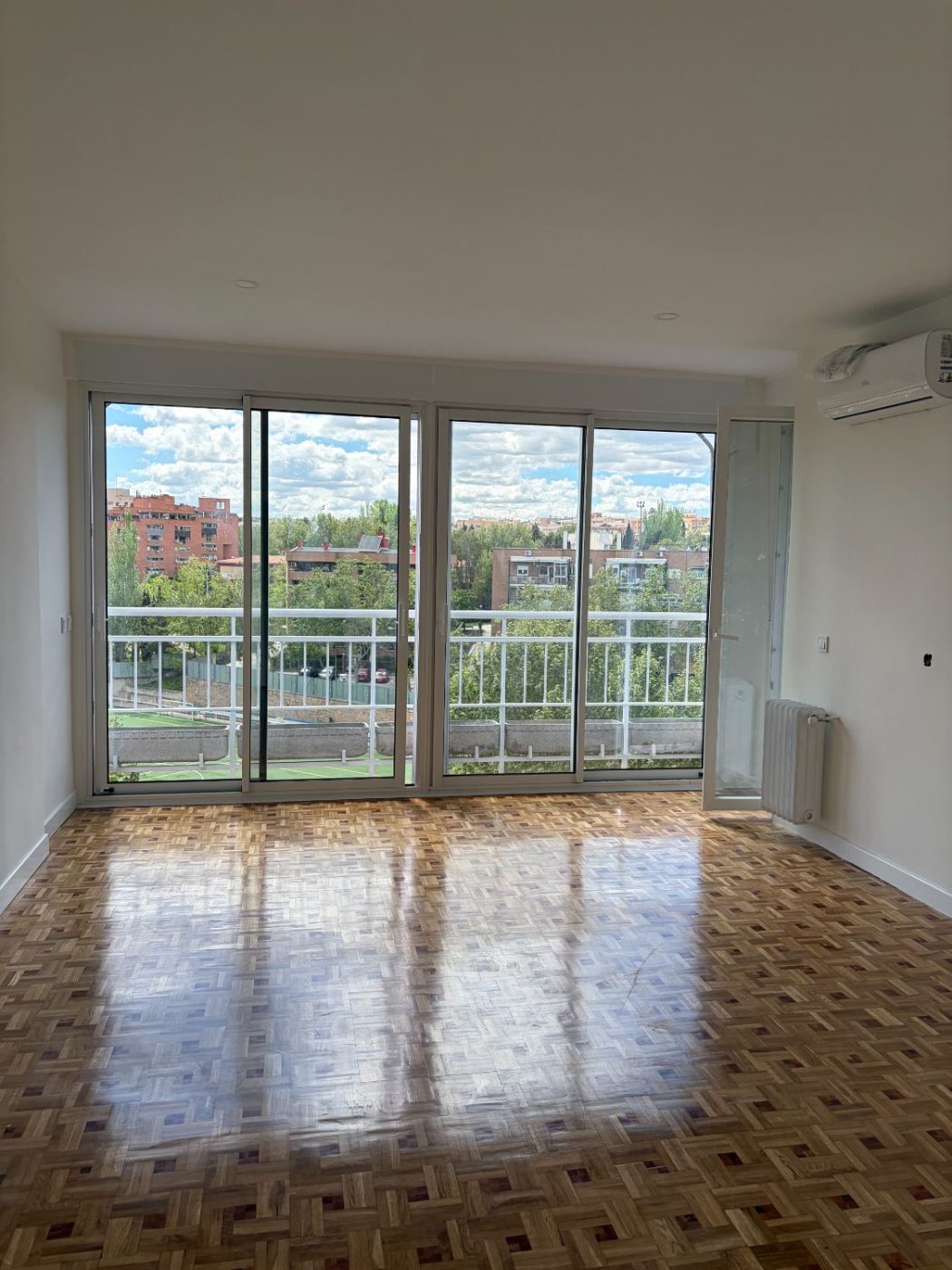 Salón terminado con parquet de mosaico y luz natural